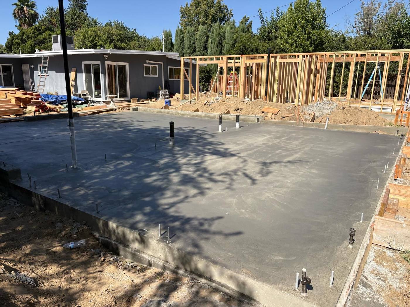 Finished ADU slab with framing going up behind