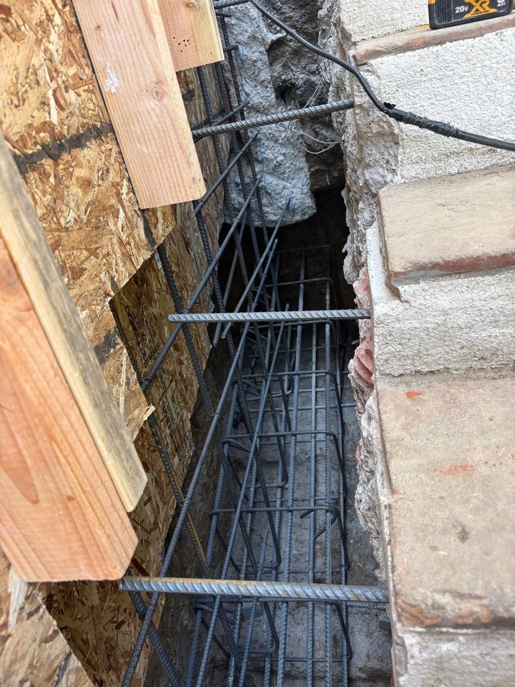 Rebar cage in a trench next to the house